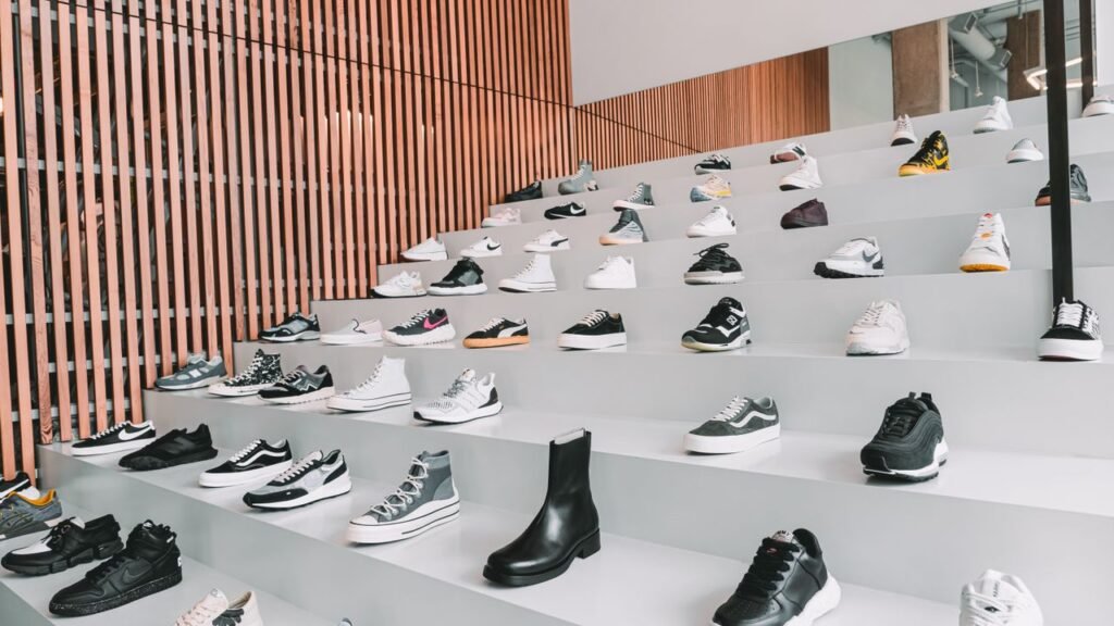 Find Your Perfect Match A diverse collection of sneakers displayed in a modern retail store with stylish interior design.